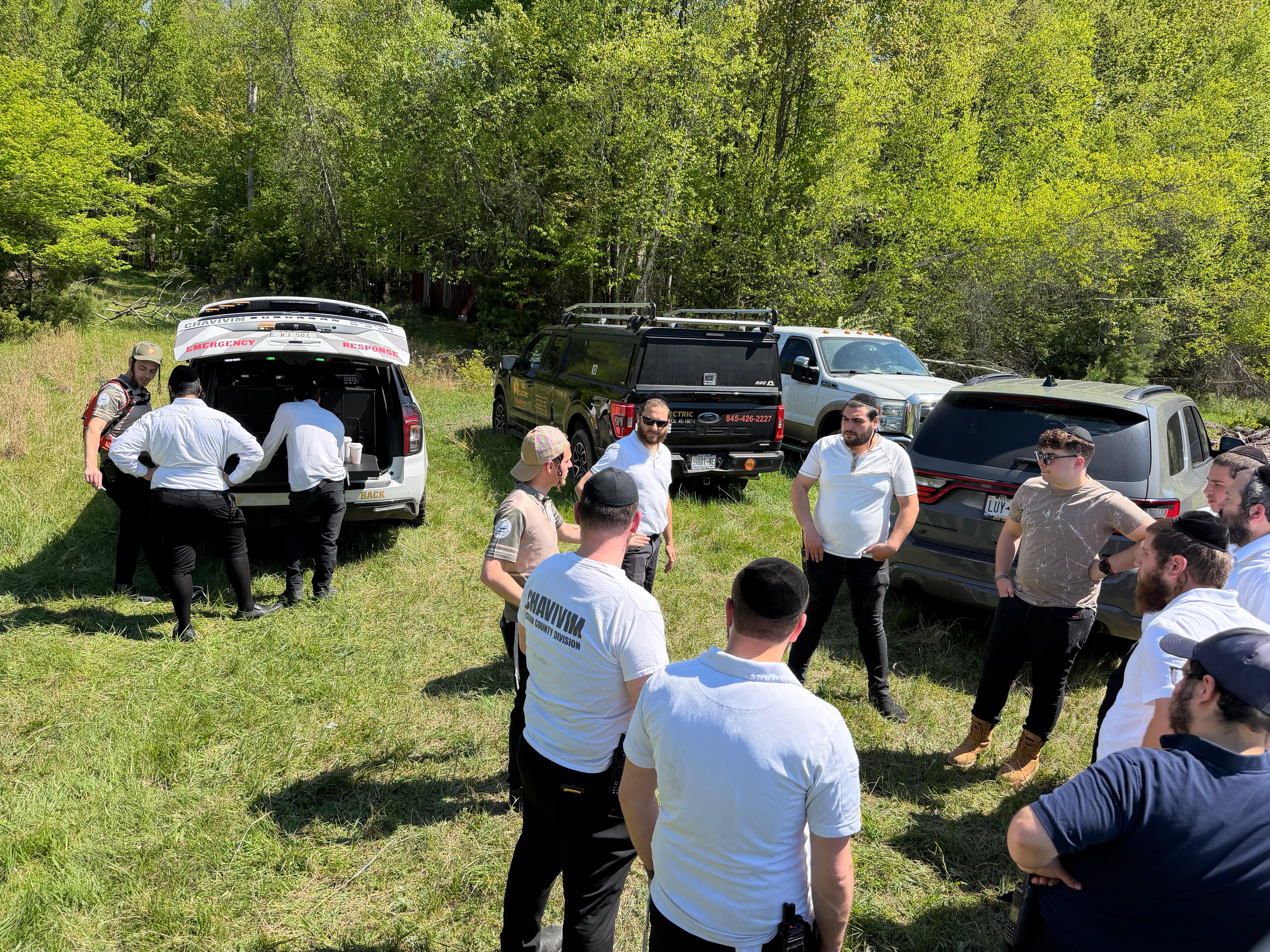 Chavivim crews regrouping for a briefing at the back of a response vehicle between training drills